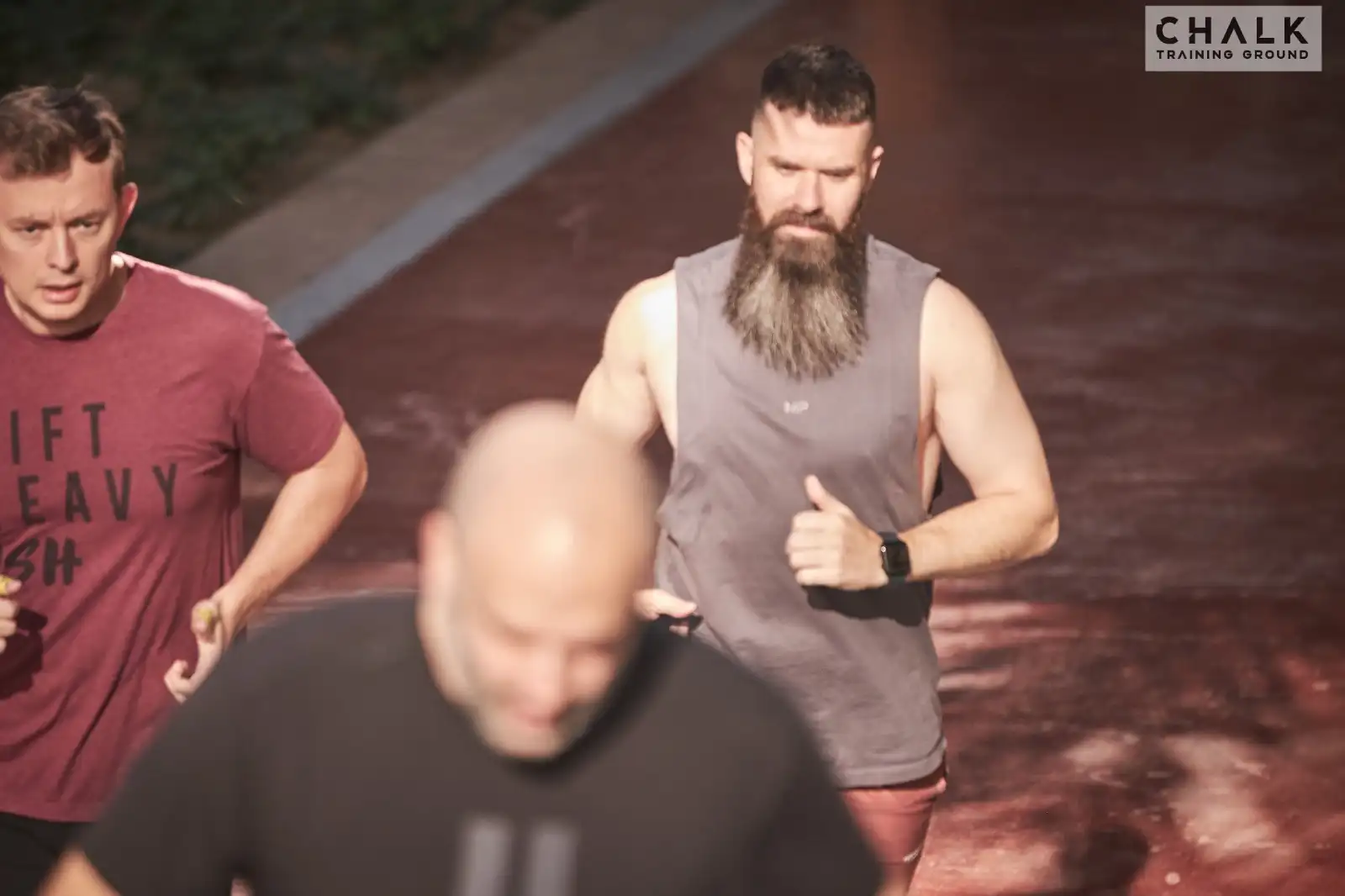 Members running together during a cardio session at Chalk Training Ground